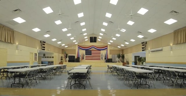 dining space featuring high vaulted ceiling, concrete flooring, and ceiling fan