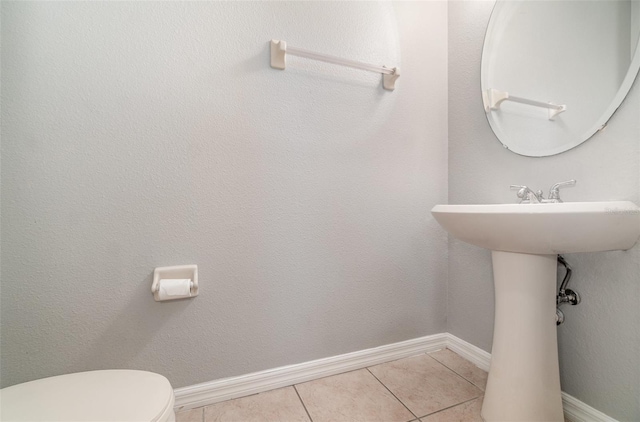 bathroom with tile patterned floors and toilet