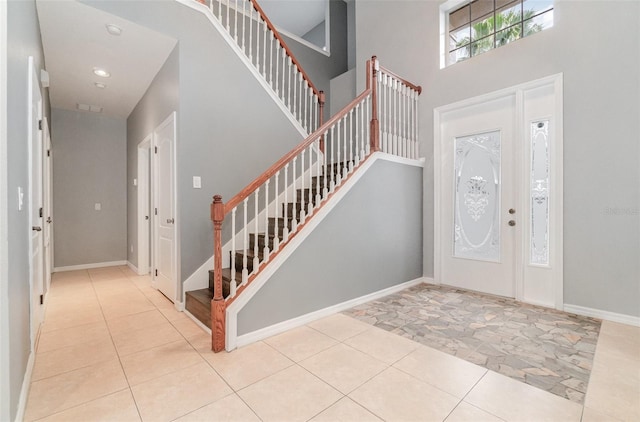 foyer featuring a towering ceiling