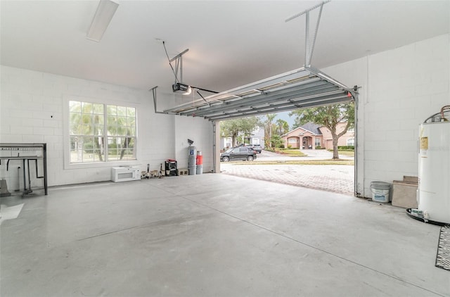 garage with water heater and a garage door opener