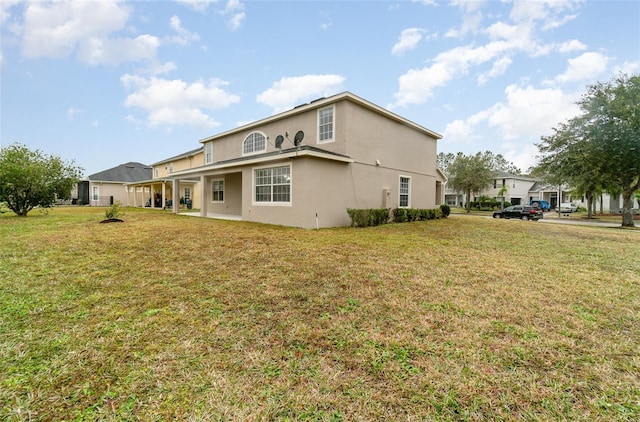 back of property featuring a yard