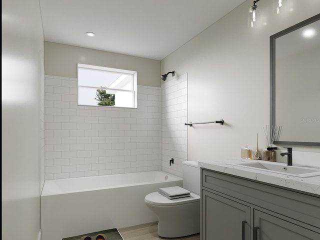 full bathroom with tiled shower / bath combo, vanity, wood-type flooring, and toilet