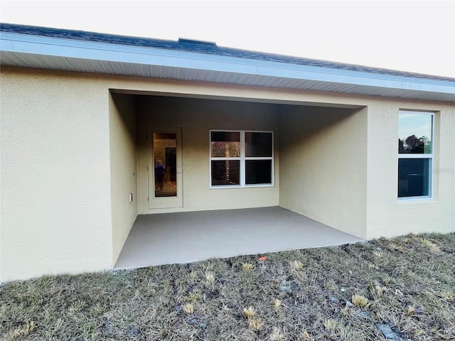 view of exterior entry featuring a patio