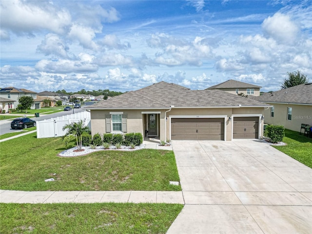 single story home with a garage and a front lawn