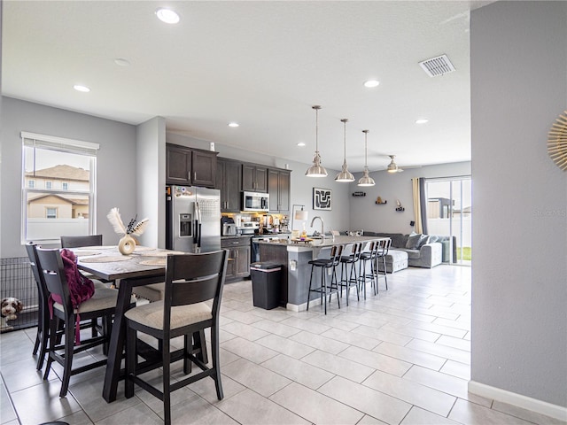 dining area with light tile patterned flooring and sink