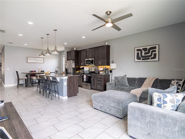 living room with sink and ceiling fan