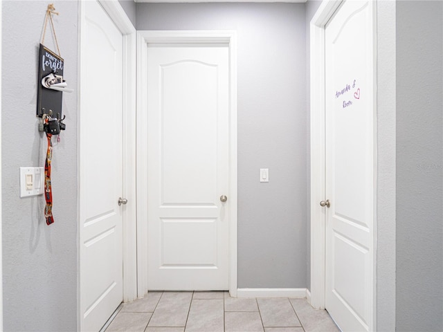 corridor with light tile patterned flooring