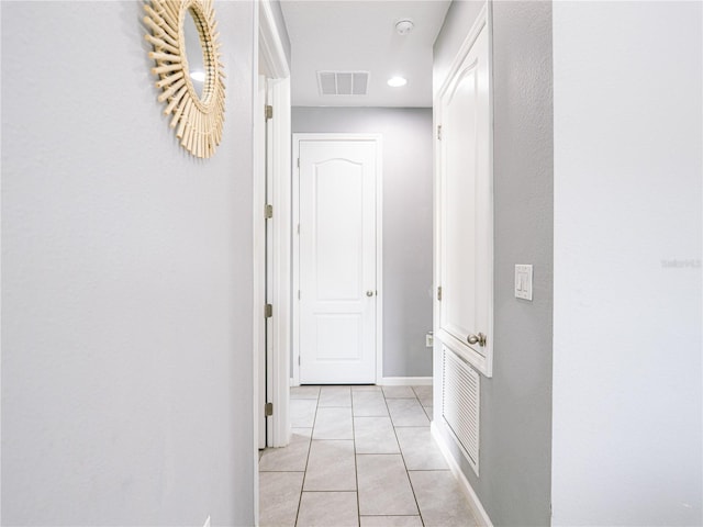 corridor featuring light tile patterned floors