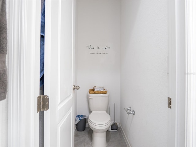 bathroom featuring tile patterned floors and toilet