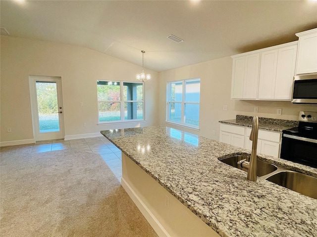 kitchen with pendant lighting, white cabinetry, sink, light stone counters, and black range with electric stovetop