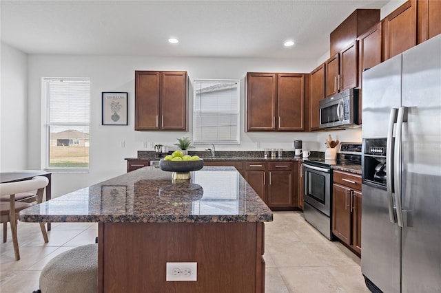 kitchen featuring a center island, dark stone counters, and appliances with stainless steel finishes