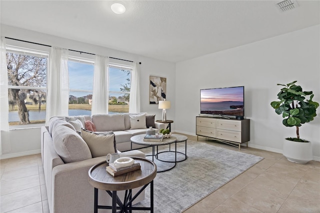 tiled living room featuring plenty of natural light