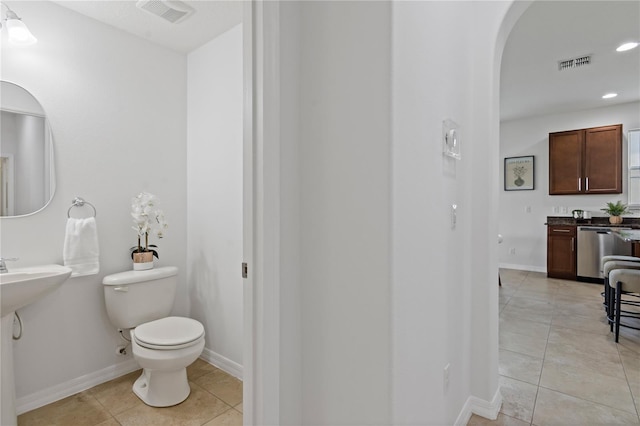 bathroom featuring tile patterned flooring and toilet