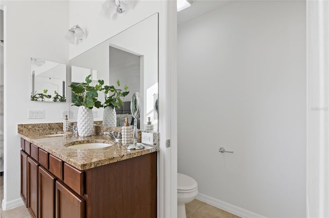 bathroom with vanity, toilet, and tile patterned flooring