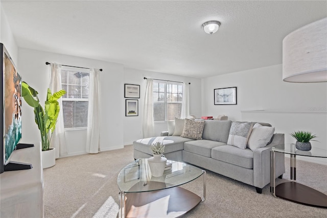 living room featuring light colored carpet and a textured ceiling