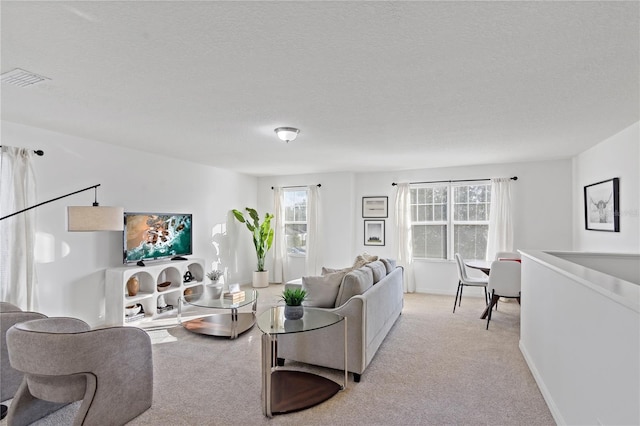 living room with light carpet and a textured ceiling