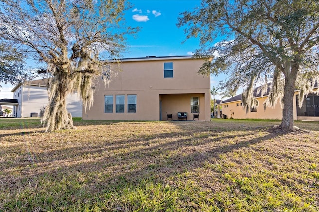 rear view of property with a yard