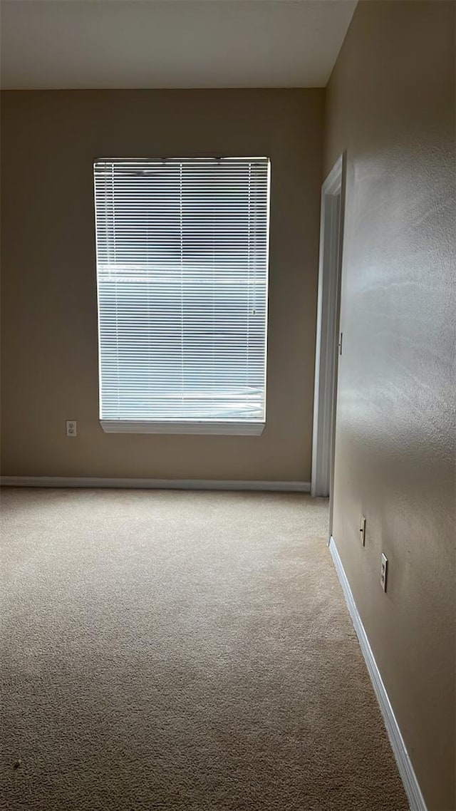 empty room with light colored carpet