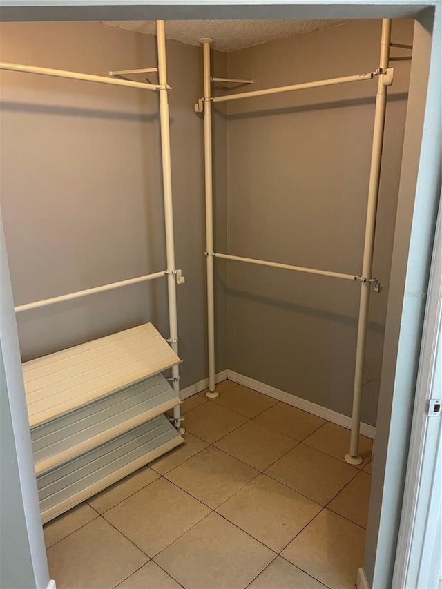 walk in closet featuring tile patterned flooring