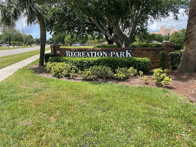 community sign featuring a lawn