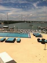 view of swimming pool with a water view and a patio