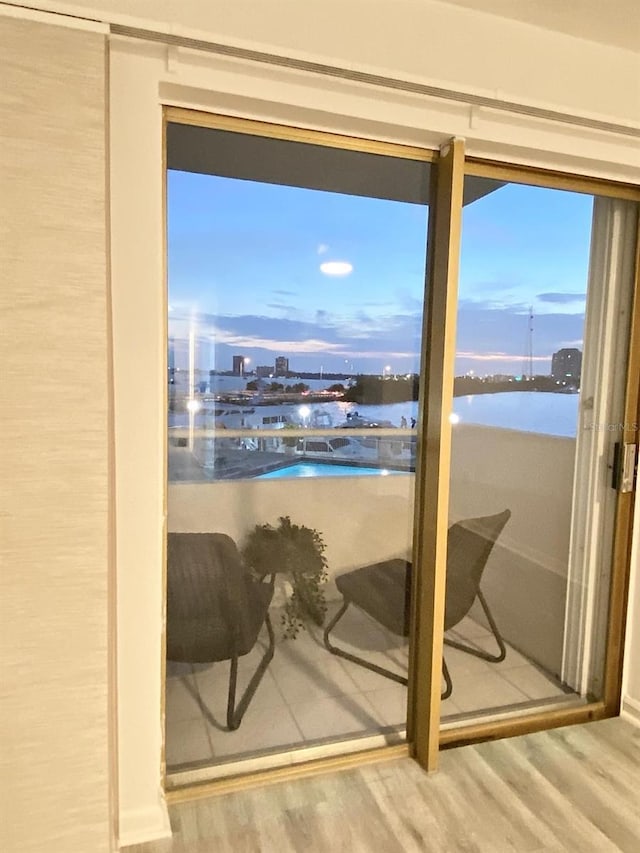 doorway to outside featuring wood-type flooring and a water view