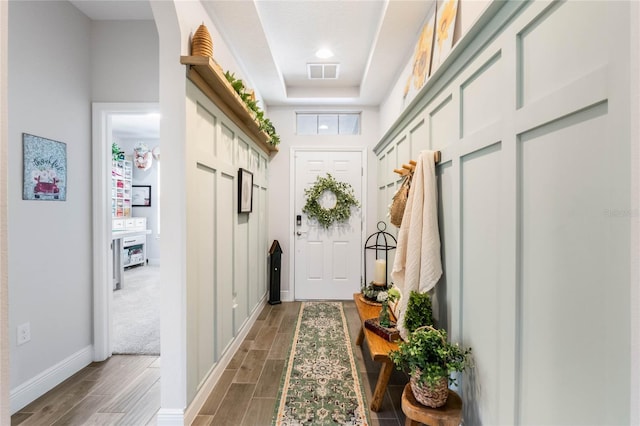 mudroom featuring a tray ceiling