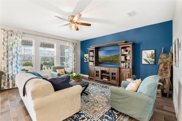 living room featuring wood-type flooring and ceiling fan