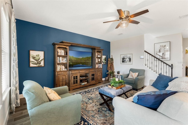 living room with dark wood-type flooring and ceiling fan