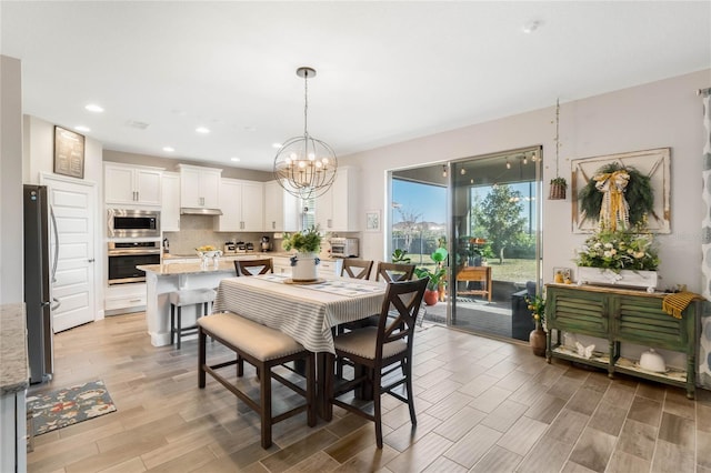 dining room with an inviting chandelier and light hardwood / wood-style floors