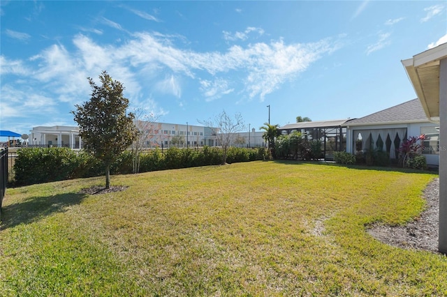 view of yard with glass enclosure