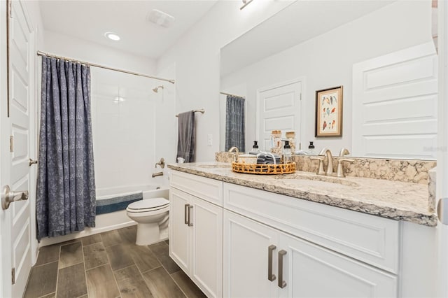 full bathroom featuring shower / bath combo, vanity, and toilet