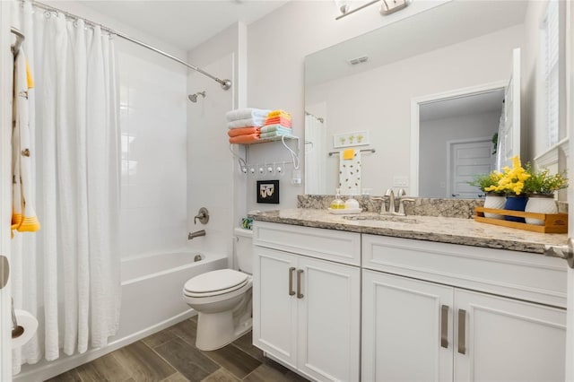 full bathroom with shower / bathtub combination with curtain, vanity, and toilet