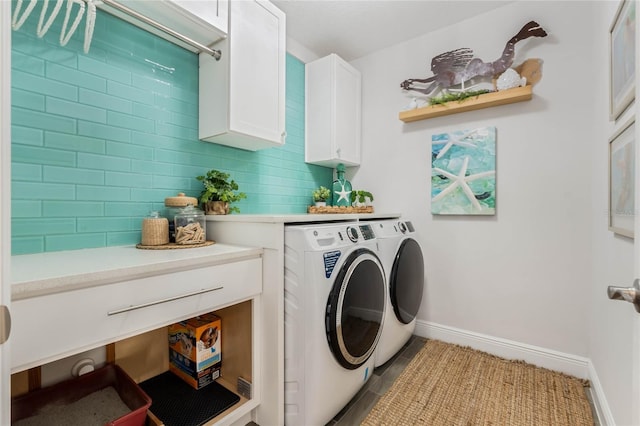 laundry area with washer and clothes dryer and cabinets