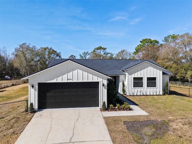 modern inspired farmhouse with a garage and a front yard