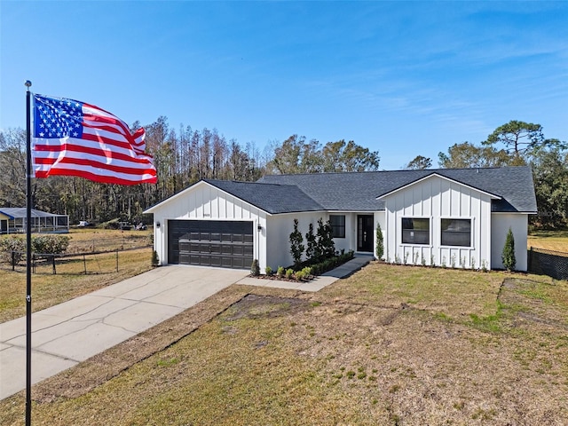 modern inspired farmhouse featuring a garage and a front lawn