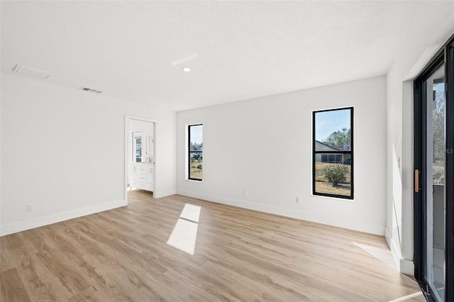 empty room with light hardwood / wood-style floors