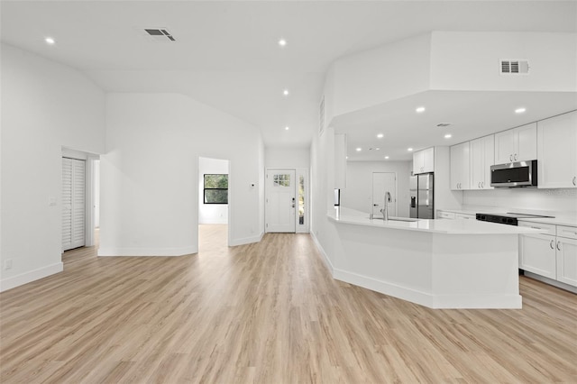 kitchen featuring light wood-type flooring, appliances with stainless steel finishes, sink, and white cabinets