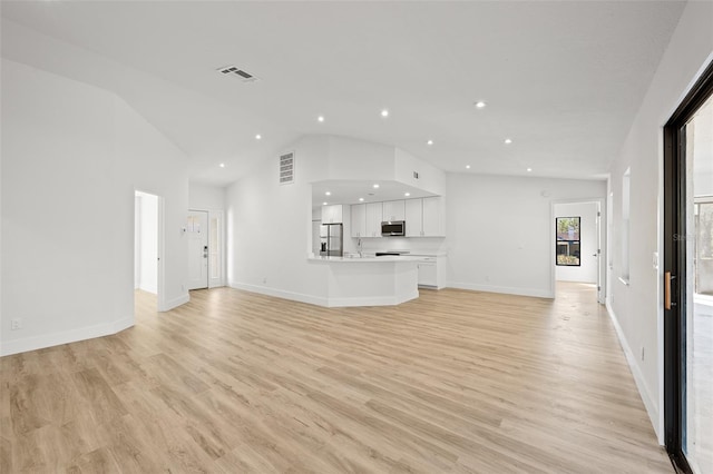 unfurnished living room featuring high vaulted ceiling and light wood-type flooring