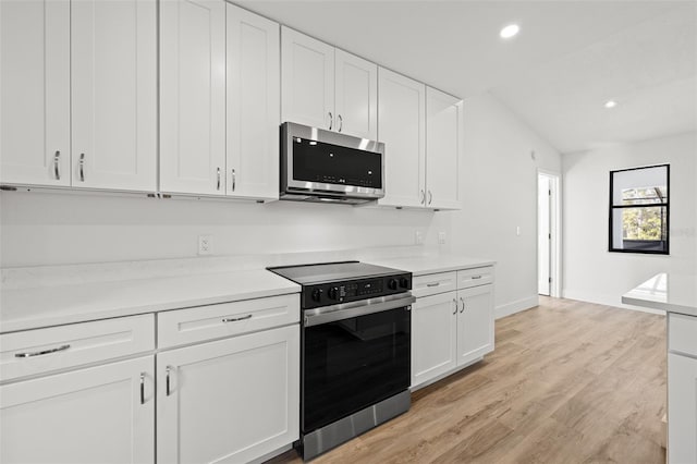 kitchen featuring white cabinetry, appliances with stainless steel finishes, and light hardwood / wood-style floors