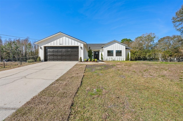 view of front of property with a garage and a front yard