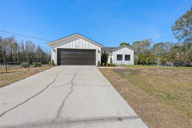 view of front of property with a garage and a front lawn