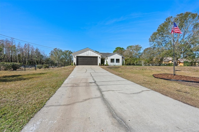 view of front of property with a garage and a front lawn