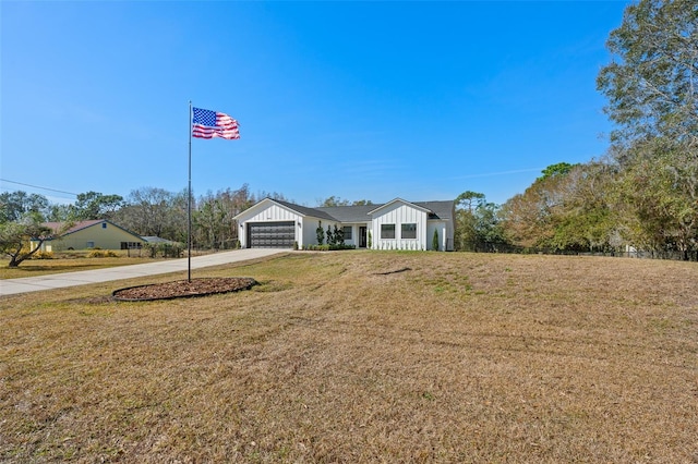 single story home featuring a garage and a front yard