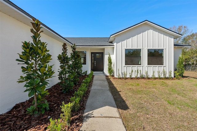 doorway to property with a yard