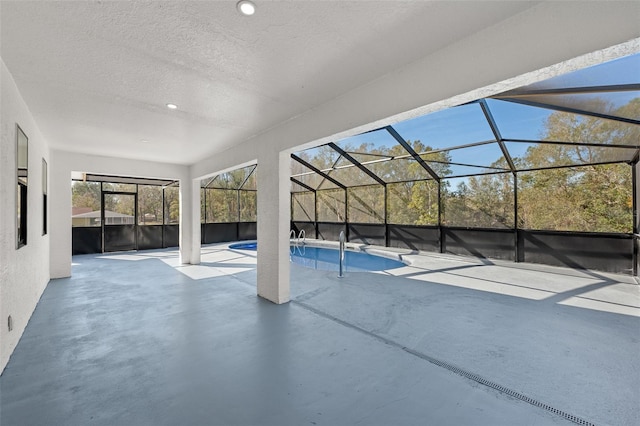 view of swimming pool with a patio and a lanai