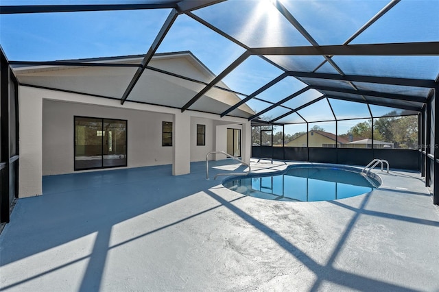 view of swimming pool with a lanai and a patio