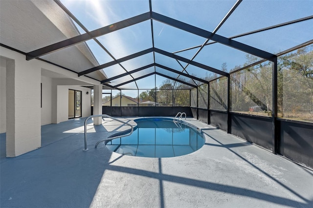 view of pool with a lanai and a patio