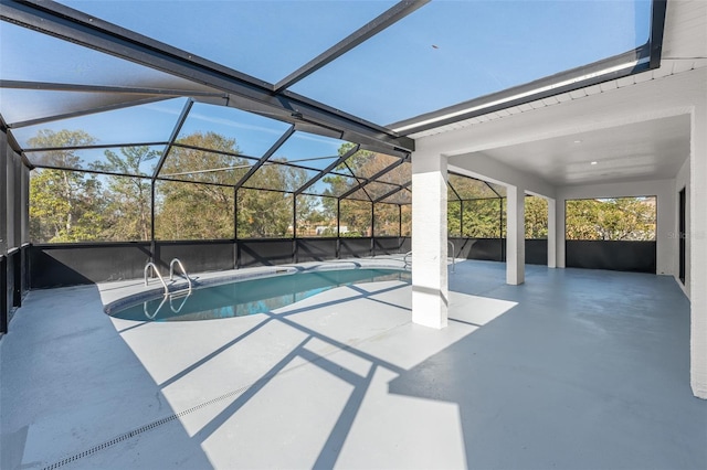 view of swimming pool featuring a lanai and a patio