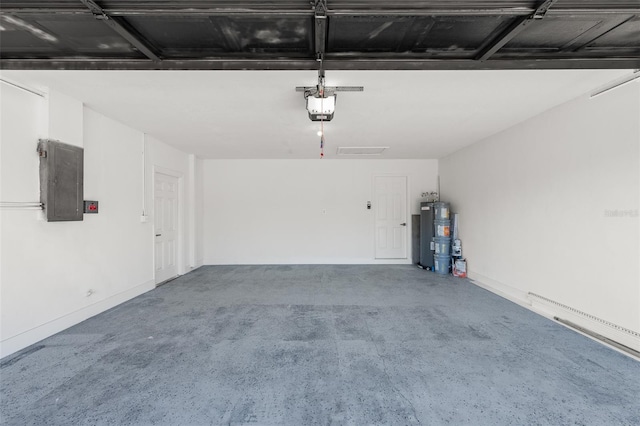 garage featuring a garage door opener, electric panel, and water heater